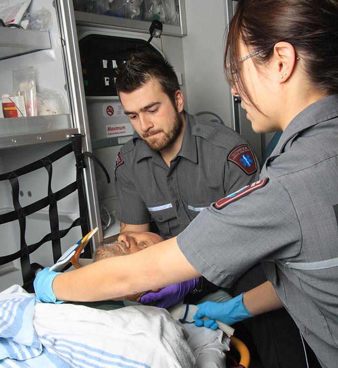 two-emt-caring-for-man-inside-ambulance